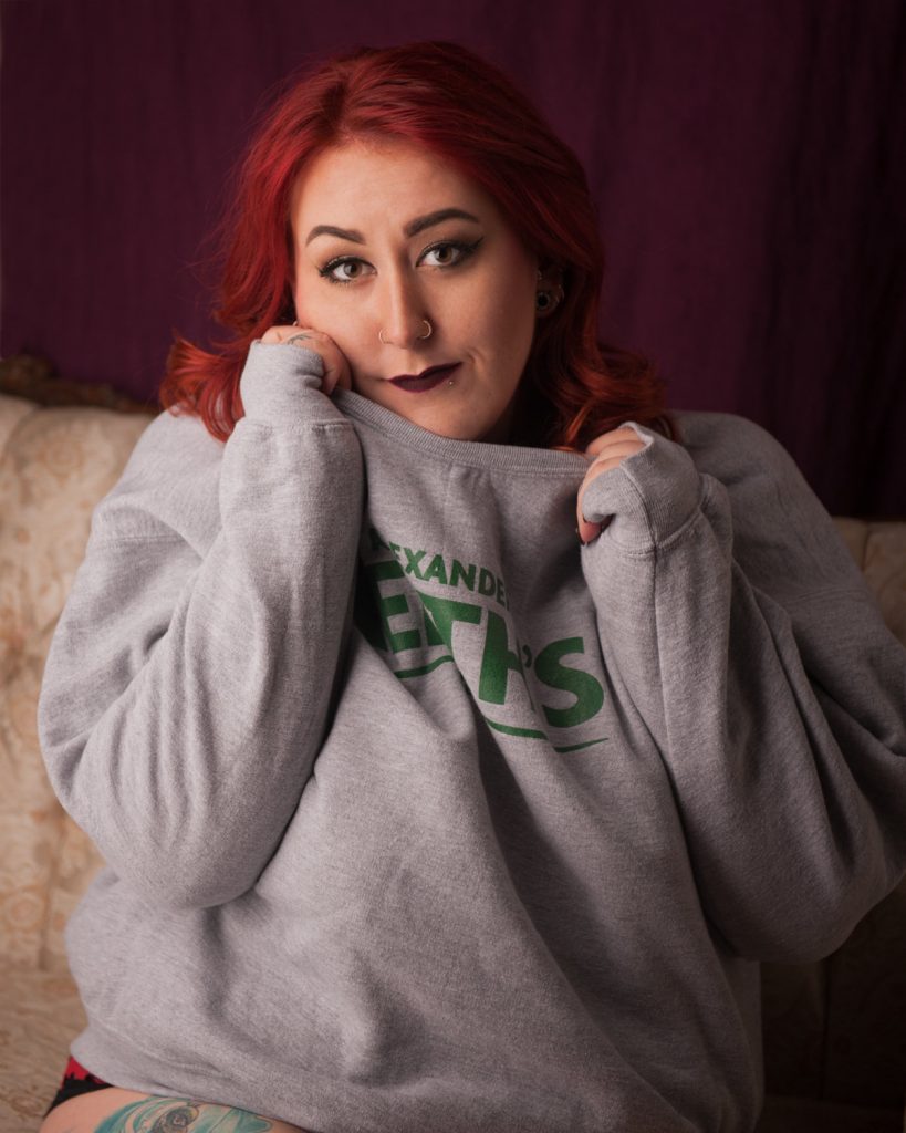 woman wearing alexander keith's sweatshirt during regina boudoir photography session