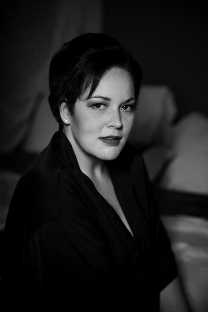 woman in black silk robe looking at camera regina boudoir photography session black and white